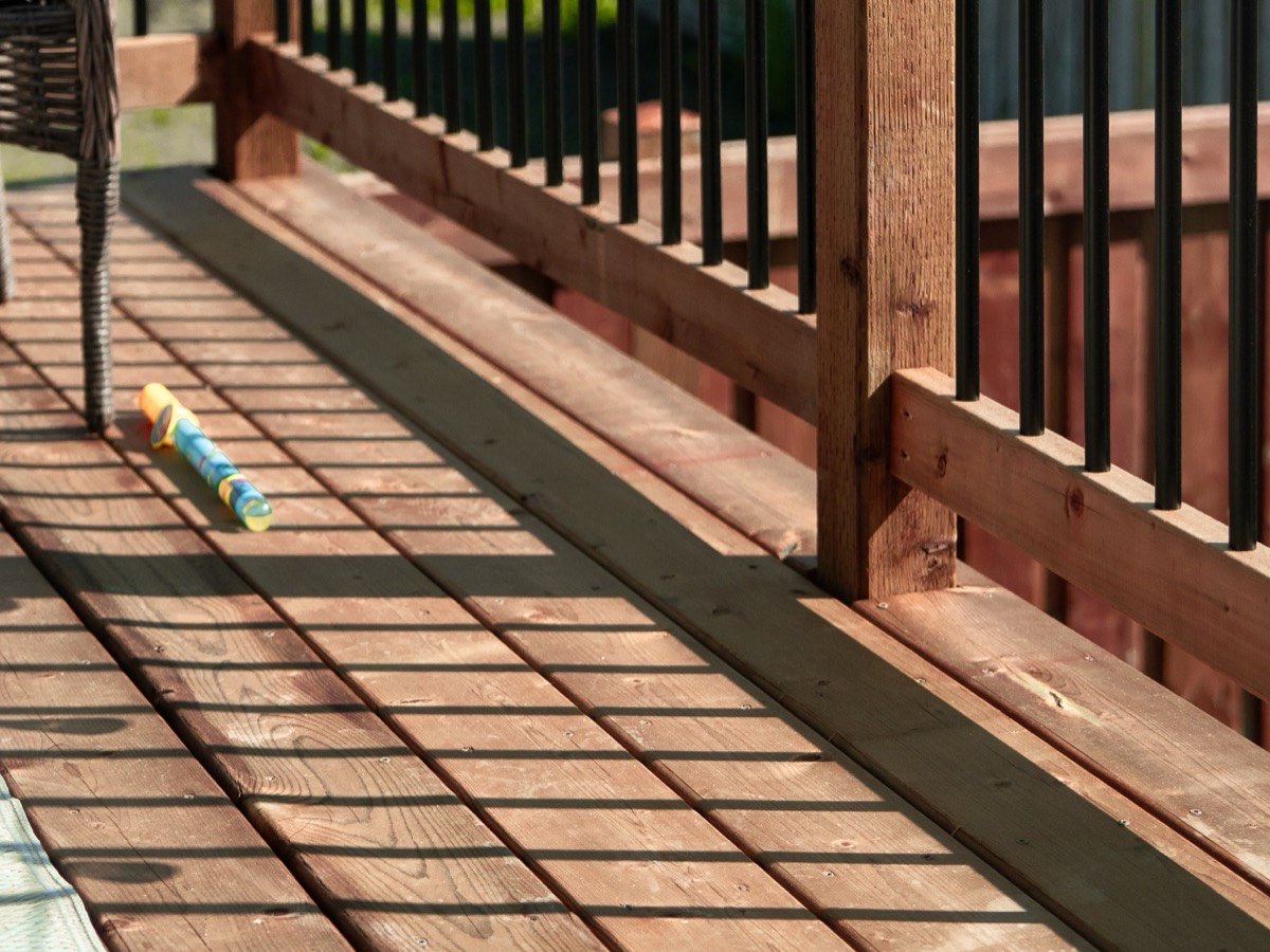 Cedar deck boards and railing in afternoon light